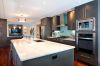 Large kitchen island with grey modern cabinetry